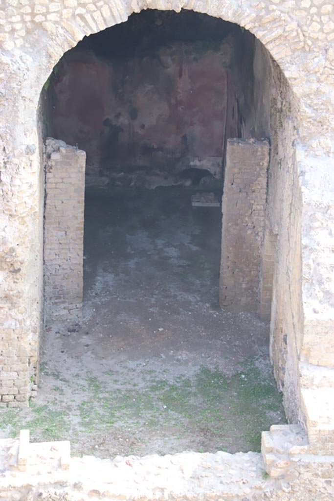 III.1/2/18/19, Herculaneum. October 2023. 
Looking north from access roadway towards room E, with room D at its rear.
Photo courtesy of Klaus Heese.